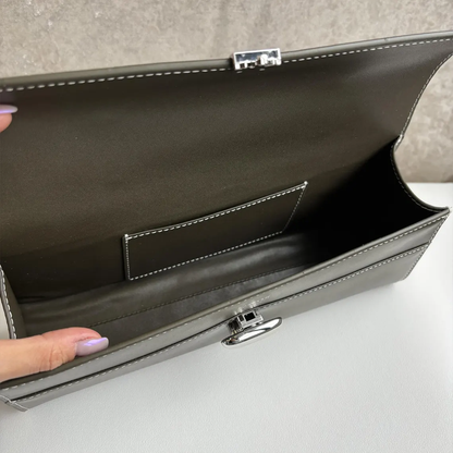 Muted Olive Grey Slim Elongated Rectangular Handheld Case With Contrast Light Stitching, Oval Metallic Twist Lock And Fixed Curved Top Carry Grip