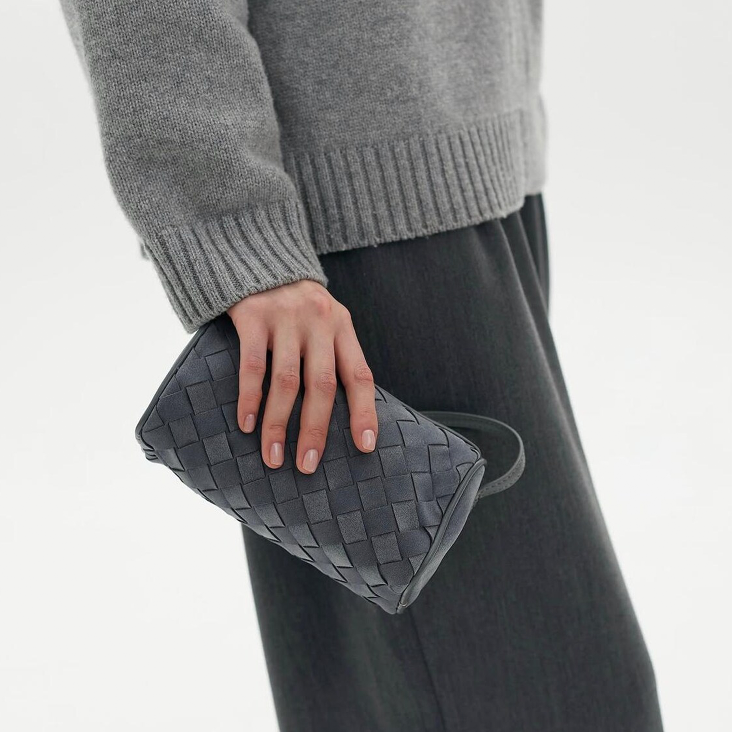 Muted Ash Grey Slim Rectangular Woven Mini Carryall With Tight Interlaced Grid Texturing, Soft Rounded Edge Trim And Slim Side Attached Hanging Strip