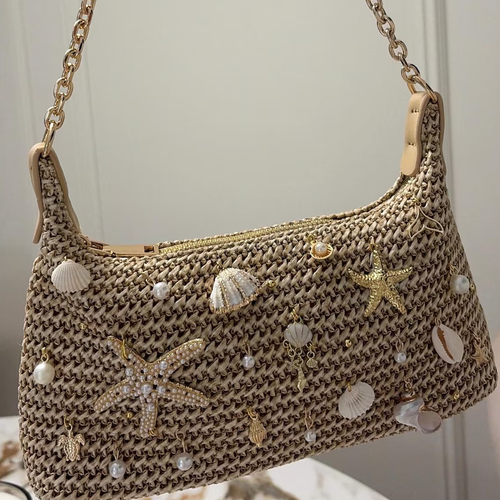Natural Sandy Beige Curved Woven Hobo Pouch With Ocean Shell Starfish Embellishments, Gold Toned Slide Closure And Linked Metal Carry Chain